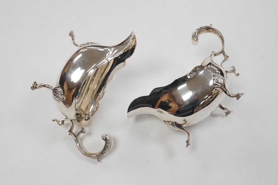 A pair of George VI silver sauce boats, with flying scroll handles, by C.J. Vander Ltd, London, 1948, length 14.3cm, 11oz.